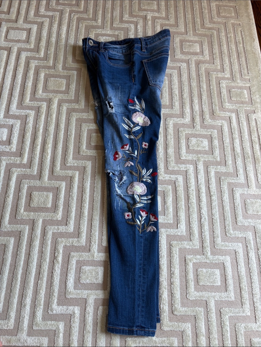 Distressed, embroidered jeans
